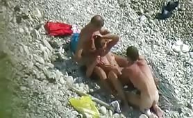 Horny girl plays with two dudes on the beach